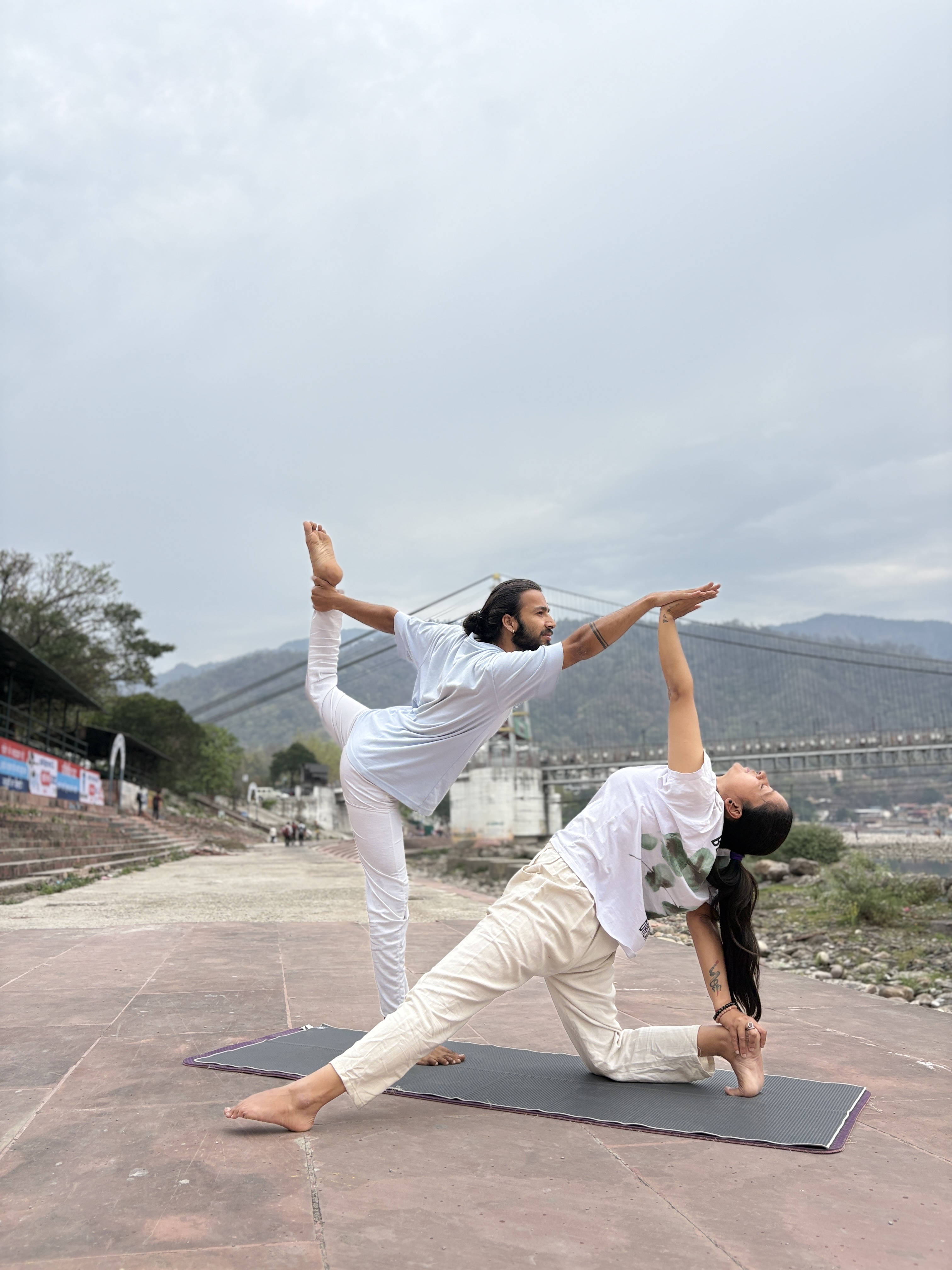 Partner yoga by the Ganga river